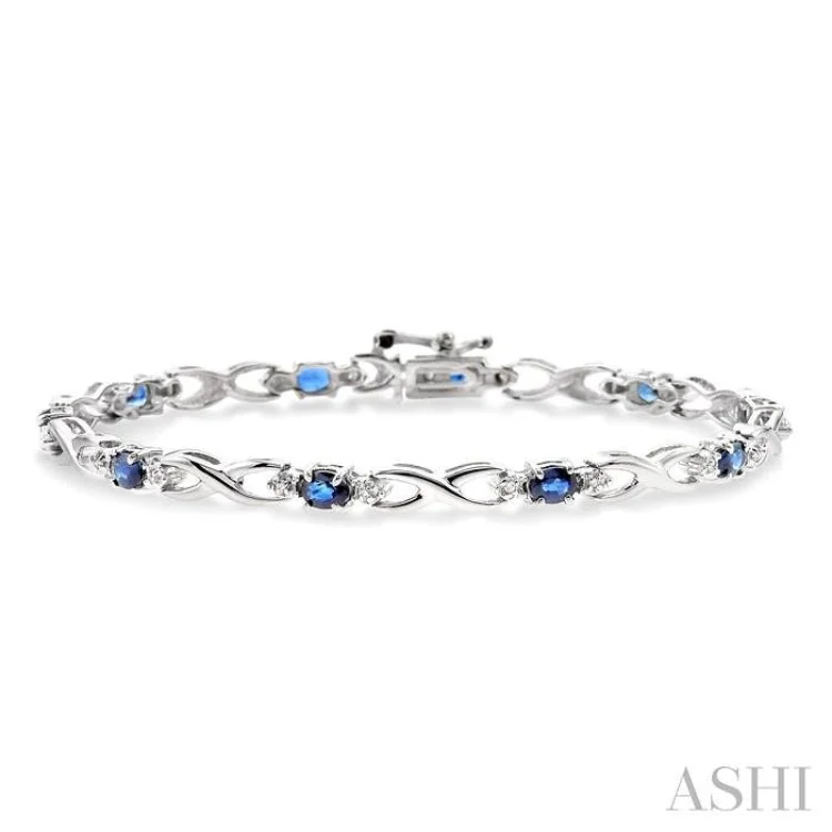 women’s sparkly bangles-4x3mm Oval Cut Sapphire and 1/10 Ctw Single Cut Diamond Bracelet in 10K White Gold