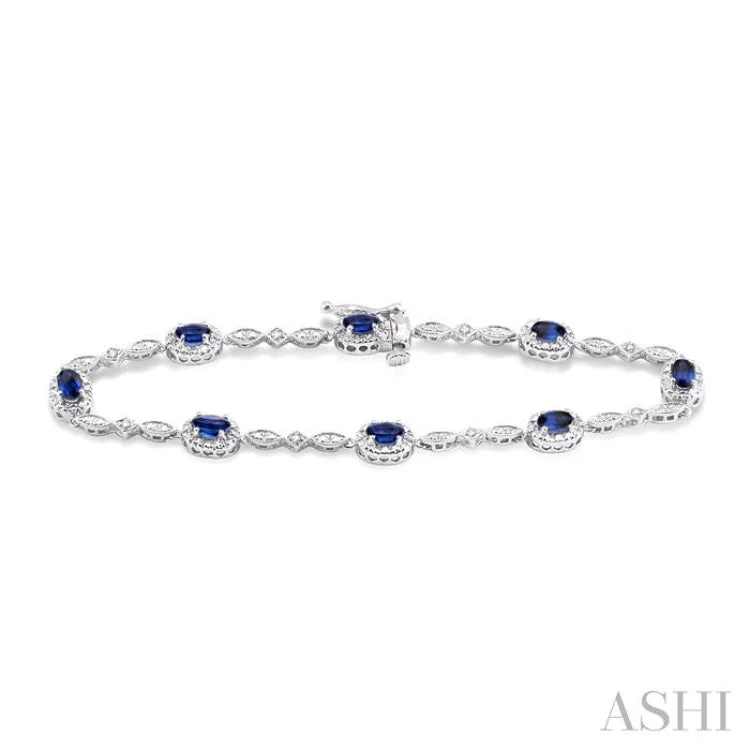 women’s adjustable bangles-5x3MM Oval Cut Sapphire and 1/20 Ctw Single Cut Diamond Bracelet in 10K White Gold